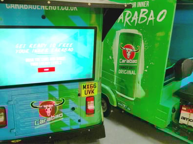 The back of the branded Carabao tuk tuk, with a touch screen display