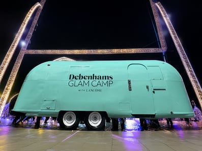 The Debenhams Glam Camp Airstream, on site at night.