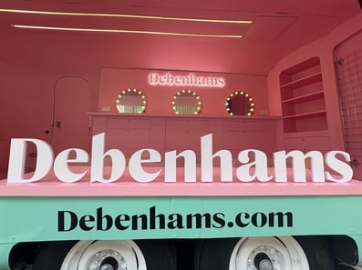 Inside the Debenhams Glam Camp vintage beauty Airstream, with a 3D logo.