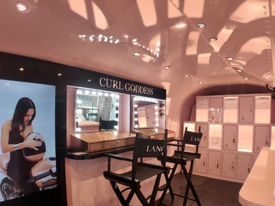Inside Lancome's custom Airstrem for a brand activation, with seating and lights.