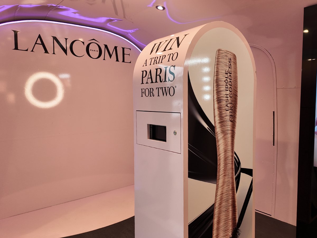 Promohire's event photo booth, hired by Lancome and wrapped in pink with black details and a lash goddess image.