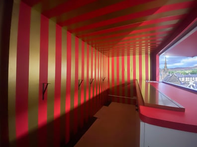Inside SHEIN's red and gold American ambulance, showing stripes and a serving hatch for a live promotional campaign.