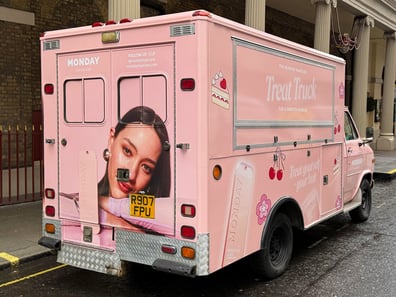 A rear view of Monday Haircare's American ambulance, with a young model's face on the back for a live experiential marketing campaign.