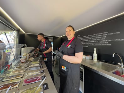Catering staff inside the KIND promotional FedEx truck, part of Promohire's fleet.