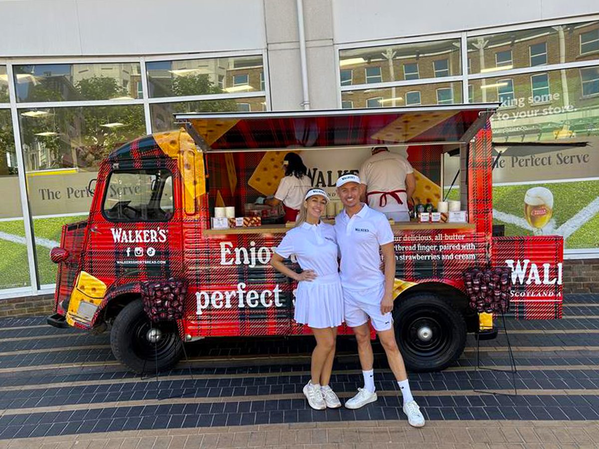A man and woman pose for Walker's Citroen H-Van idea - handing out free samples for social media posts.