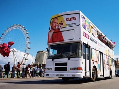 The open-top branded bus for Popmart, pictured with the London Eye, wrapped by Promohire.