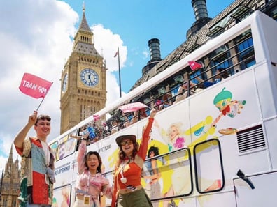 The Popmart open-top bus in London, with a crowd and Big Ben.