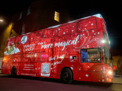 A red Christmas campaign bus for Yankee Candle as part of a live brand activation/promotion.