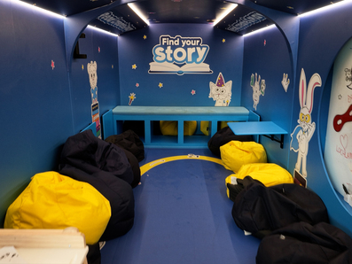 A lounge area inside the Find Your Story book immersive bus.