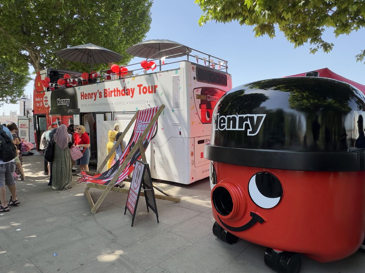A giant Henry model next to one of Promohire's double-decker buses - wrapped and customised for Henry Hoover's 45th Anniversary.