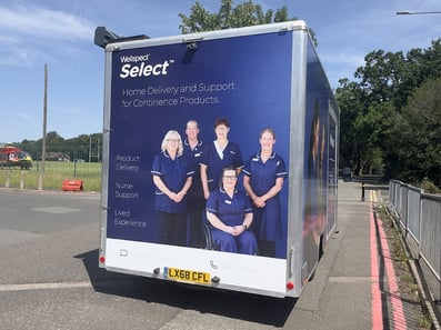 A rear view of the Wellspect exhibition vehicle from Promohire, with healthcare professionals pictured.