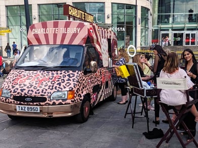 The Charlotte Tilbury promotional ice cream van with guests, playing on vehicle trends.
