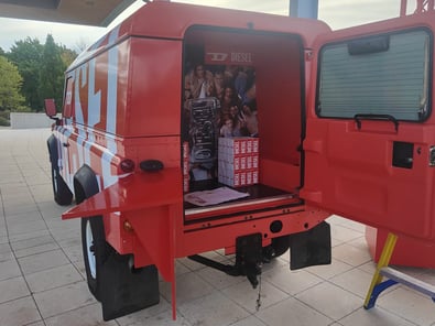 Inside the DIESEL Land Rover Defender, with a product sampling and display area at the rear.