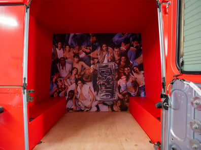 A product display and storage space inside the red Land Rover Defender, by Promohire.