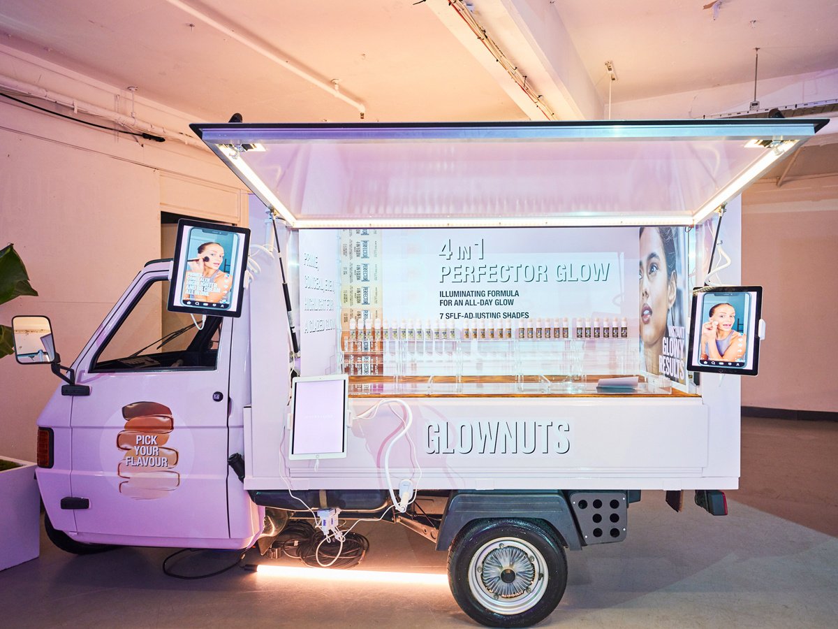 The 'Look Left' and 'Maybelline' promotional vehicle, lit up for an indoor brand activation or event.