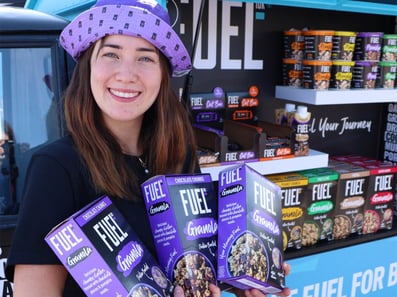 A brand ambassador smiles at FUEL's brand pop-up experience.