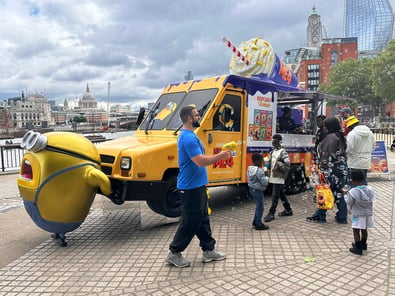 A US postal van for Despicable Me in London, with a family gathered, in association with Promohire and Universal Studios.