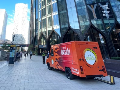 A food and beverage brand vehicle, displayed in orange for Wasabi, in London.