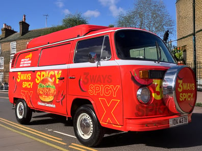 A red sampling camper van from Jollibee as part of a student marketing campaign.