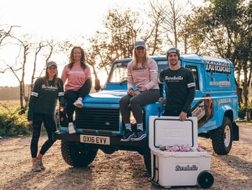 Blue Barebells Land Rover Defender with engagement team