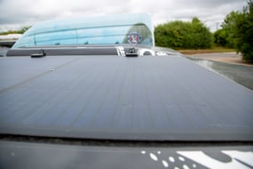 Solar panels on a black land rover defender