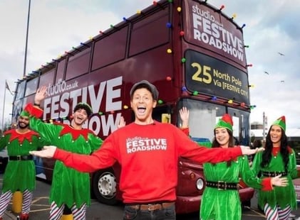 Joe Swash and a team of elves pose in front of a bus. This was Studio's festive influencer marketing idea.