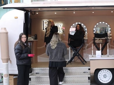 Staff and a guest at the Beauty Works live activation.