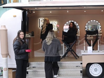 Guests are welcomed on board Beauty Works' premium Airstream trailer, with branding, 3D props, and lighting.
