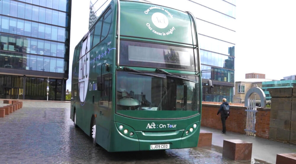 A bus driver takes ACT's mobile exhibition bus, a modern double-decker, out on tour.