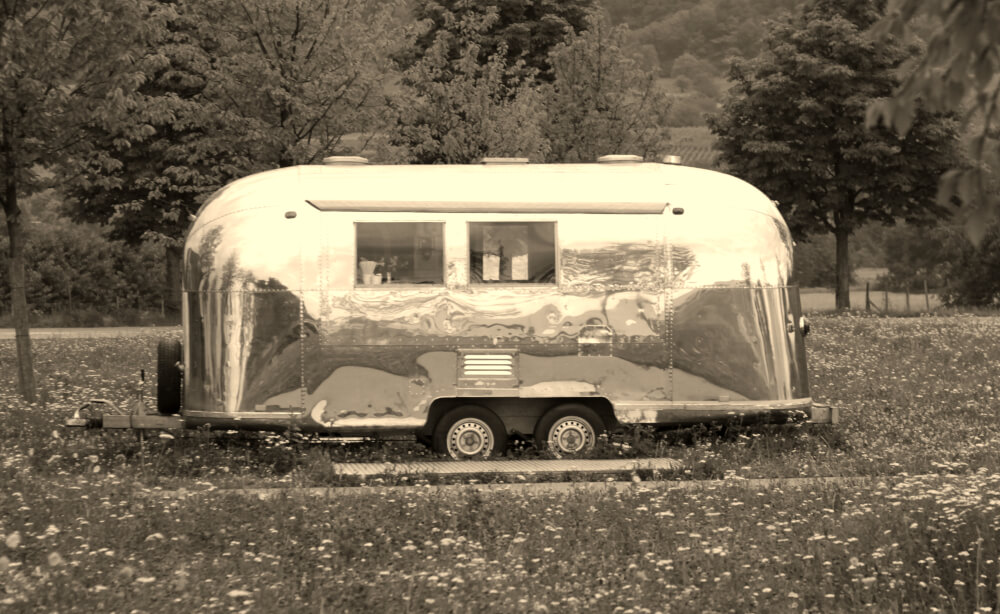 A sepia image of an Airstream, depicting the trailer's place in history.