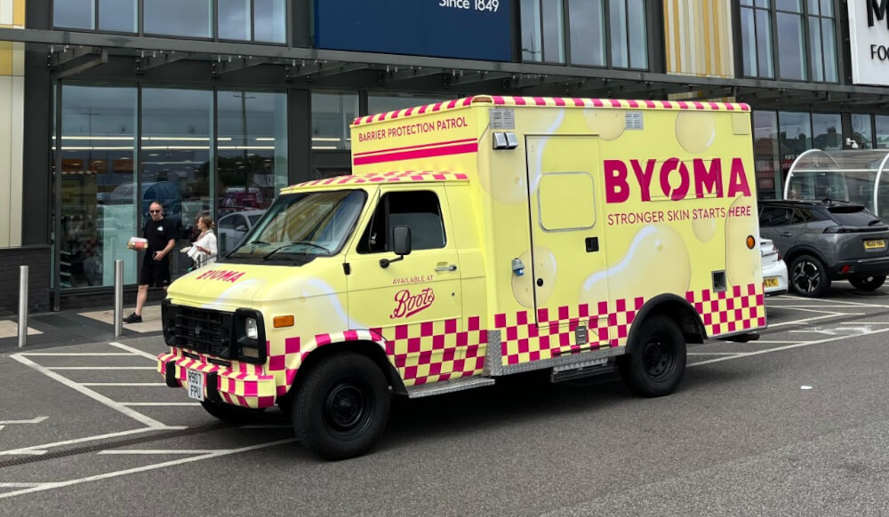 BYOMA's yellow American ambulance, wrapped and delivered by Promohire for a live brand activation.