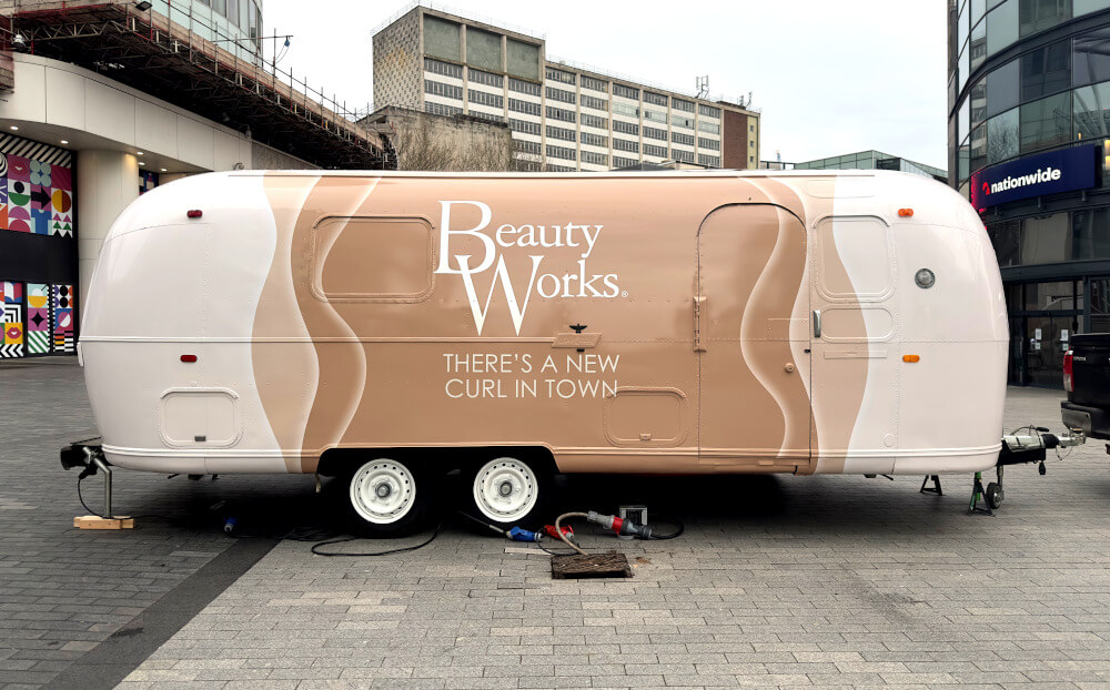 The rear of the Beauty Works Airstream, with logistics by Promohire.