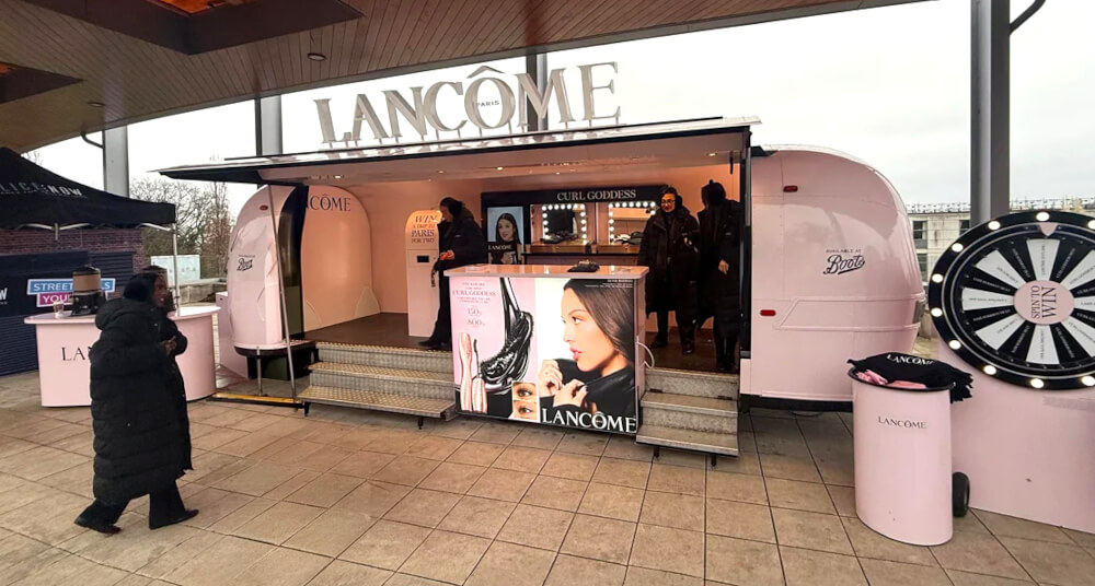 A beauty brand readies its campaign Airstream for a live event, with staff present.