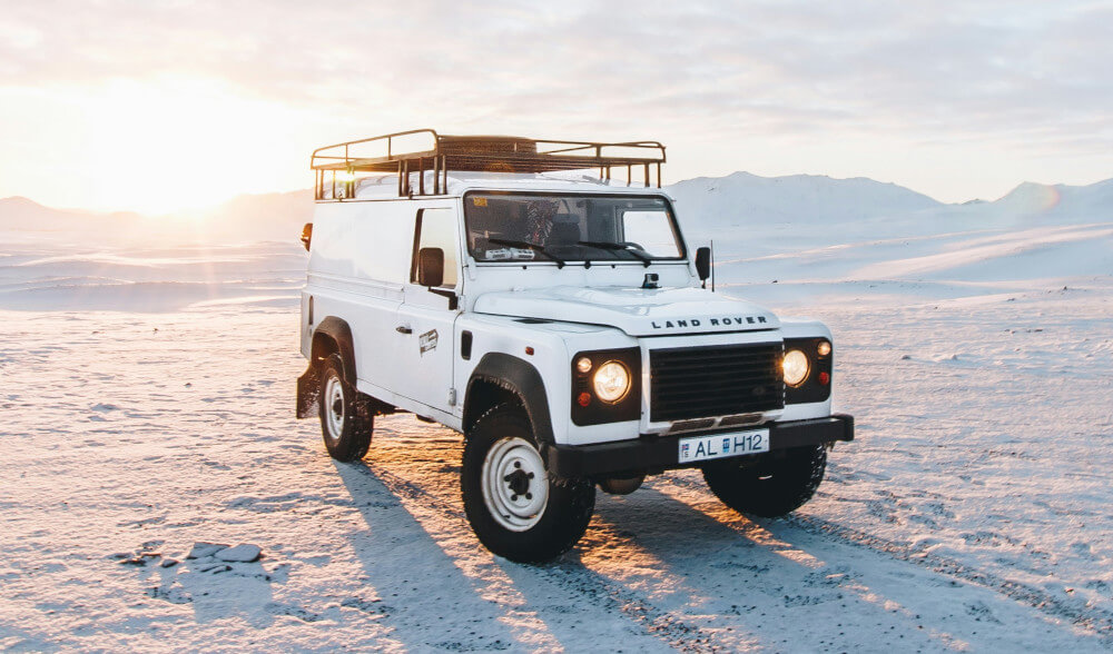 A classic Land Rover Defender, in white, which is a part of British history.