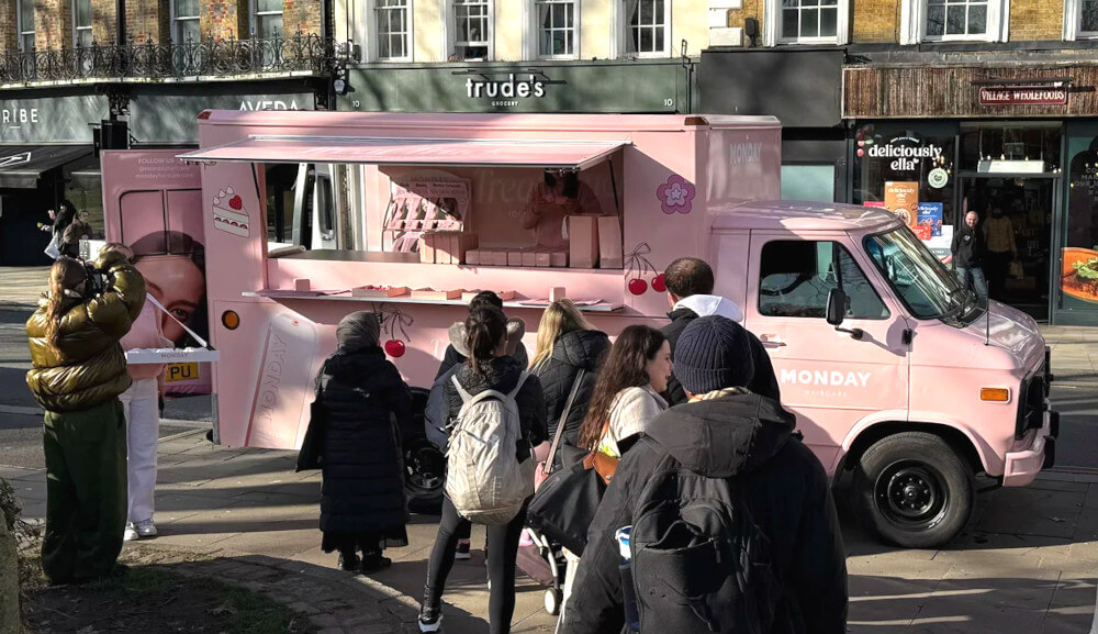 A crowd gathers at the pink Monday American ambulance as part of a live sampling campaign.