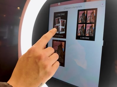 A man uses the Promohire photobooth touch screen to take photos.