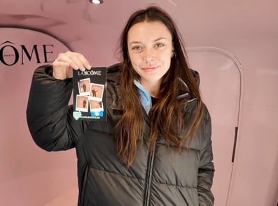 A woman holds her photo taken at a beauty campaign.