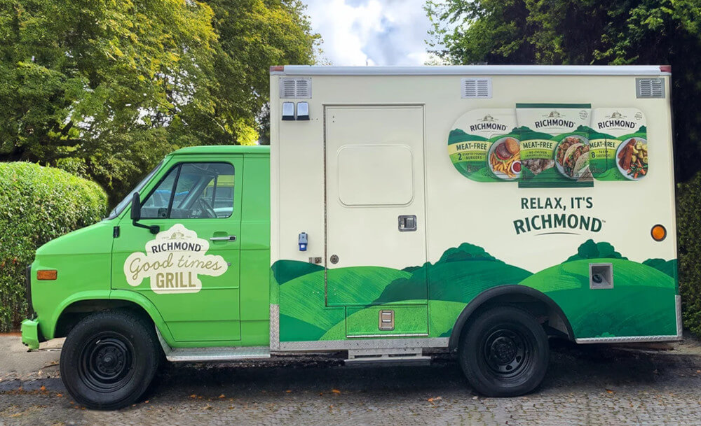 A green and white American ambulance from Promohire, with vehicle branding for Richmond Sausages' experiential marketing campaign.