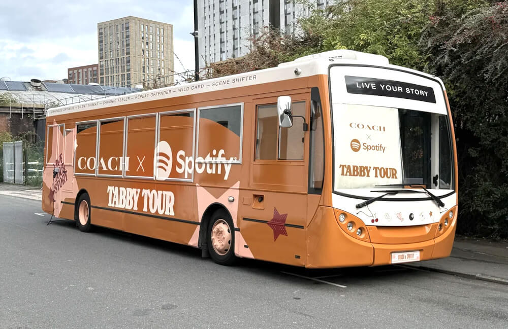 The single-decker branded promotional bus hire, in place for the Spotify & COACH Tabby Tour brand activation.