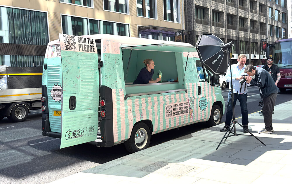 The Strong Roots for Oral Health Citroen H Van, with a woman inside and a content team filming in London.