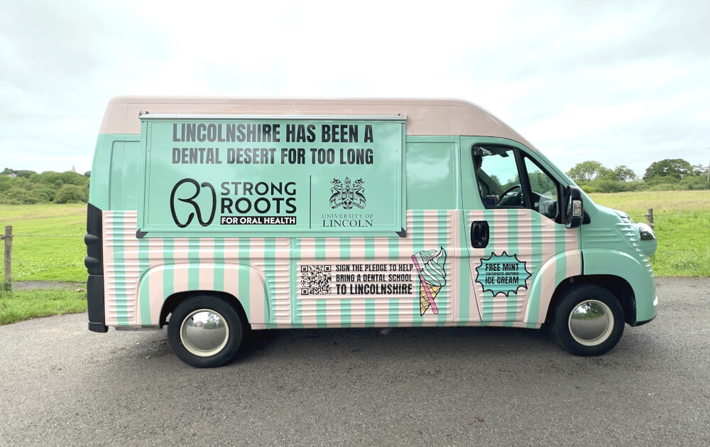 A side view of a Citroen H Van, branded for the University of Lincoln Strong Roots for Oral Health campaign, designed for community engagement.
