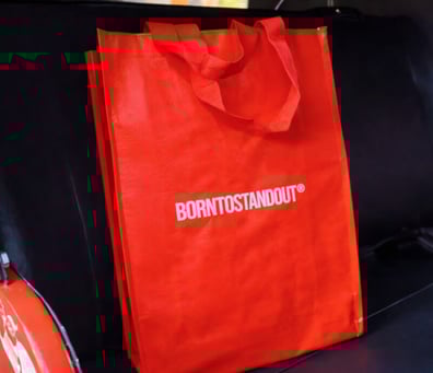A branded bag from Born to Stand Out's fragrance campaign.