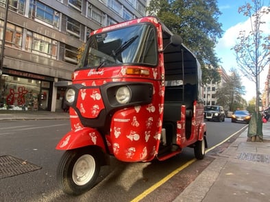 A red custom tuk tuk for Born to Stand Out's influencer campaign in London.
