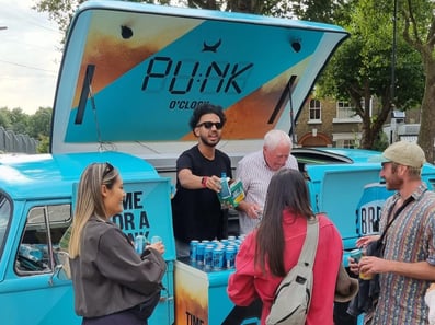 A small crowd enjoys samples from BrewDog's pop-up sampling Camper Van.
