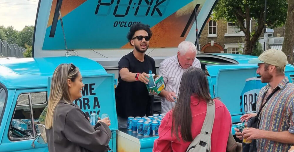 Promotional staff handing out freebies at the Brewdog roadshow campaign.