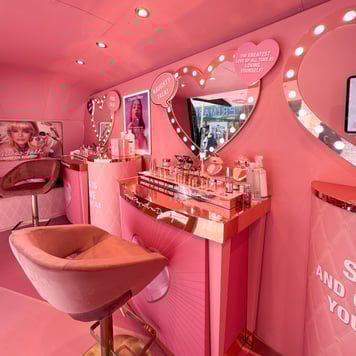 Inside Charlotte Tilbury's interactive campaign Airstream, with seating and a glamour mirror.