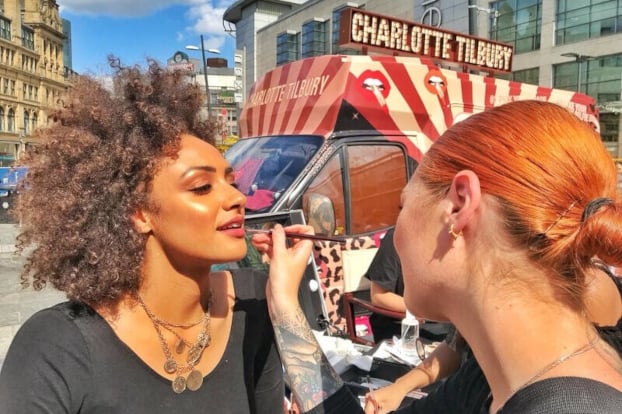 A model gets a makeover at the Charlotte Tilbury beauty advertising event in London.