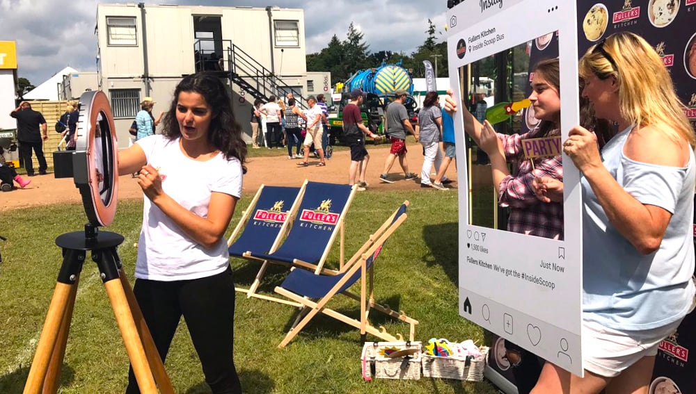 Three women get involved at a experiential event with branded deckchairs and a photo-op