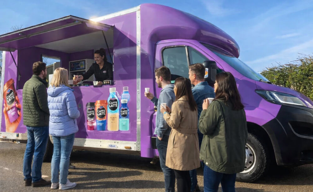 A crowd at Emmi's drink sampling mobile sampling van, with free caffe lattes given out.