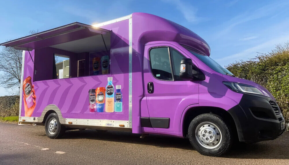 The purple Emmi Caffe Latte sampling van